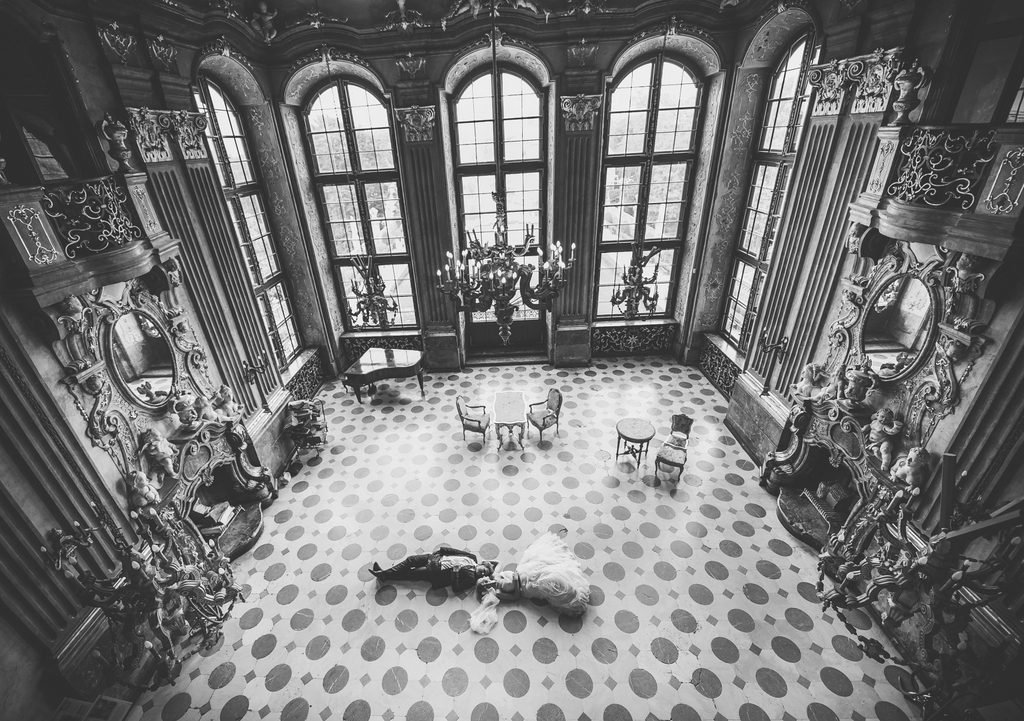 Para młoda lezy na podlodze w pałacowym wnętrzu, zamek Książ